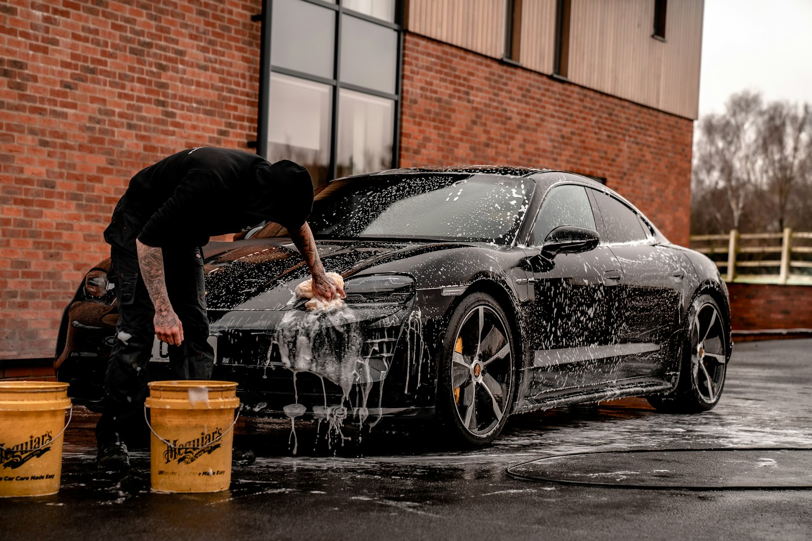 Hand wash and decontamination on a dark vehicle