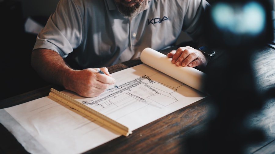 Architects reviewing blueprints at desk in design studio