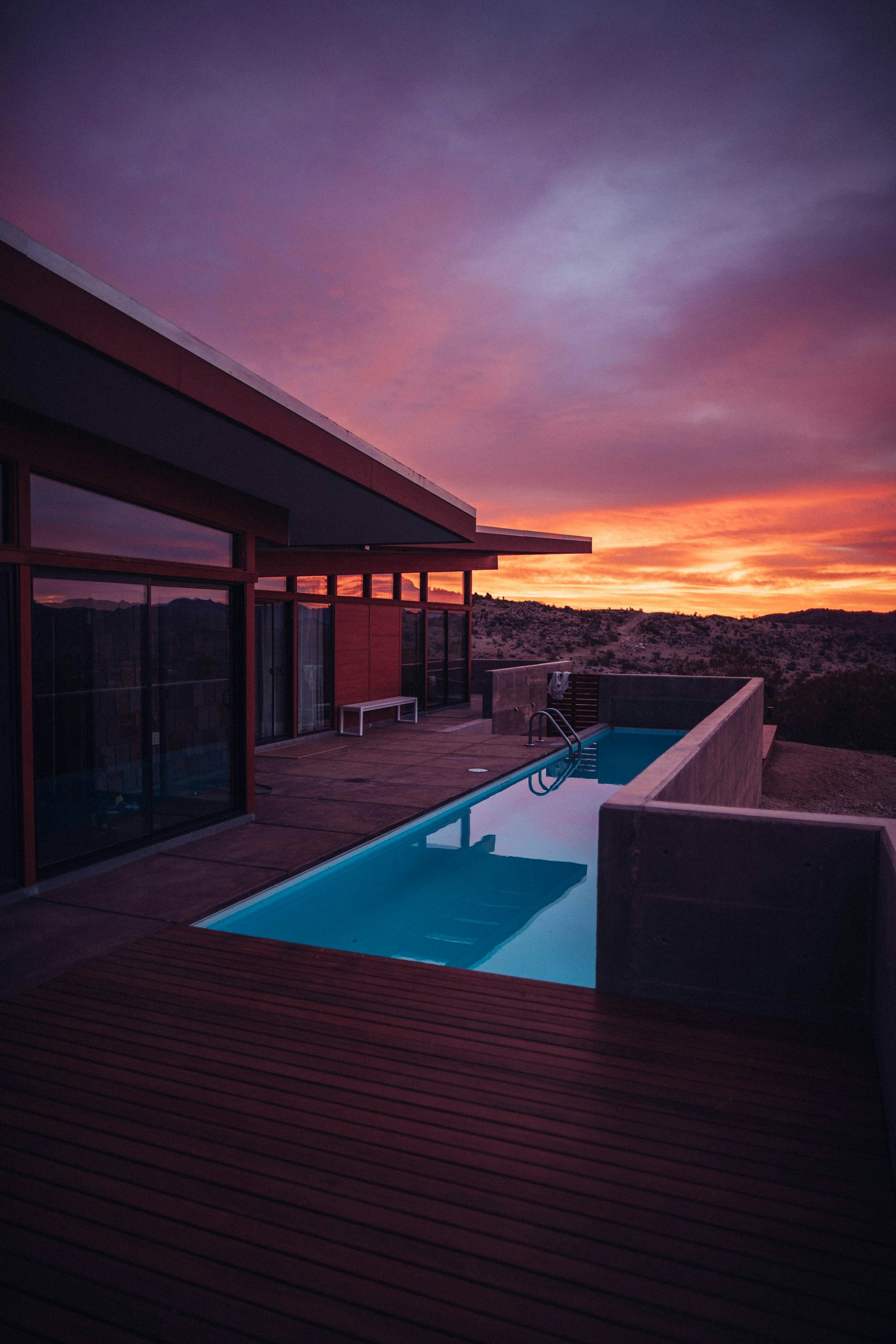 Modern desert architecture with pool reflecting golden hour light in Sedona, Arizona