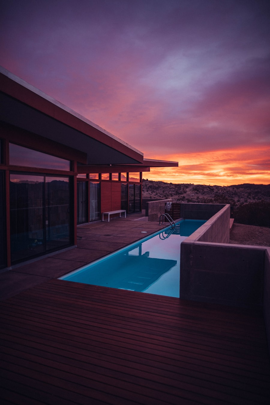 Modern desert home with pool reflecting golden hour light