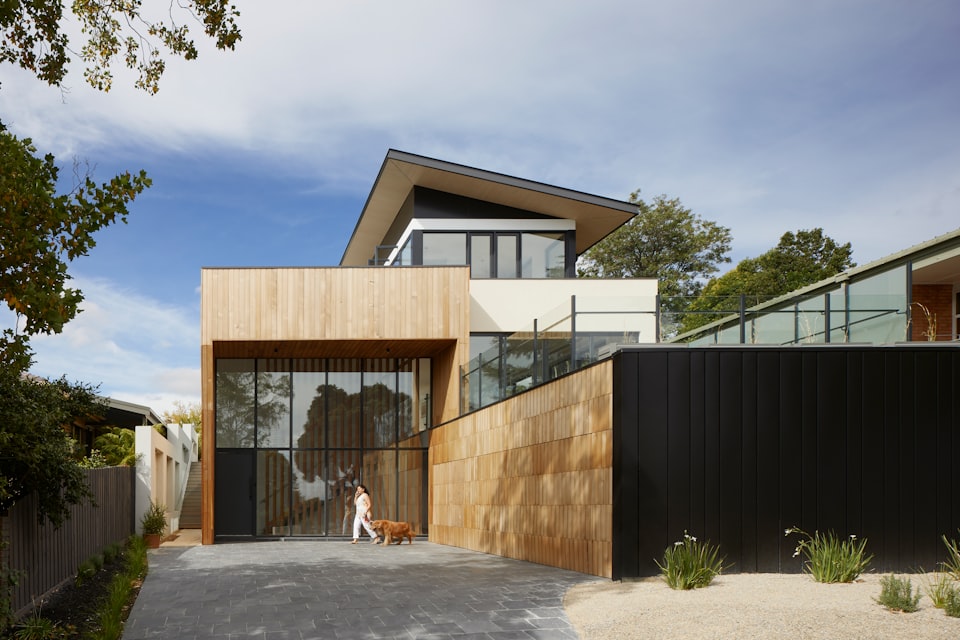 Red Rock Residence, primary bedroom with floor-to-ceiling glass framing Cathedral Rock at sunset